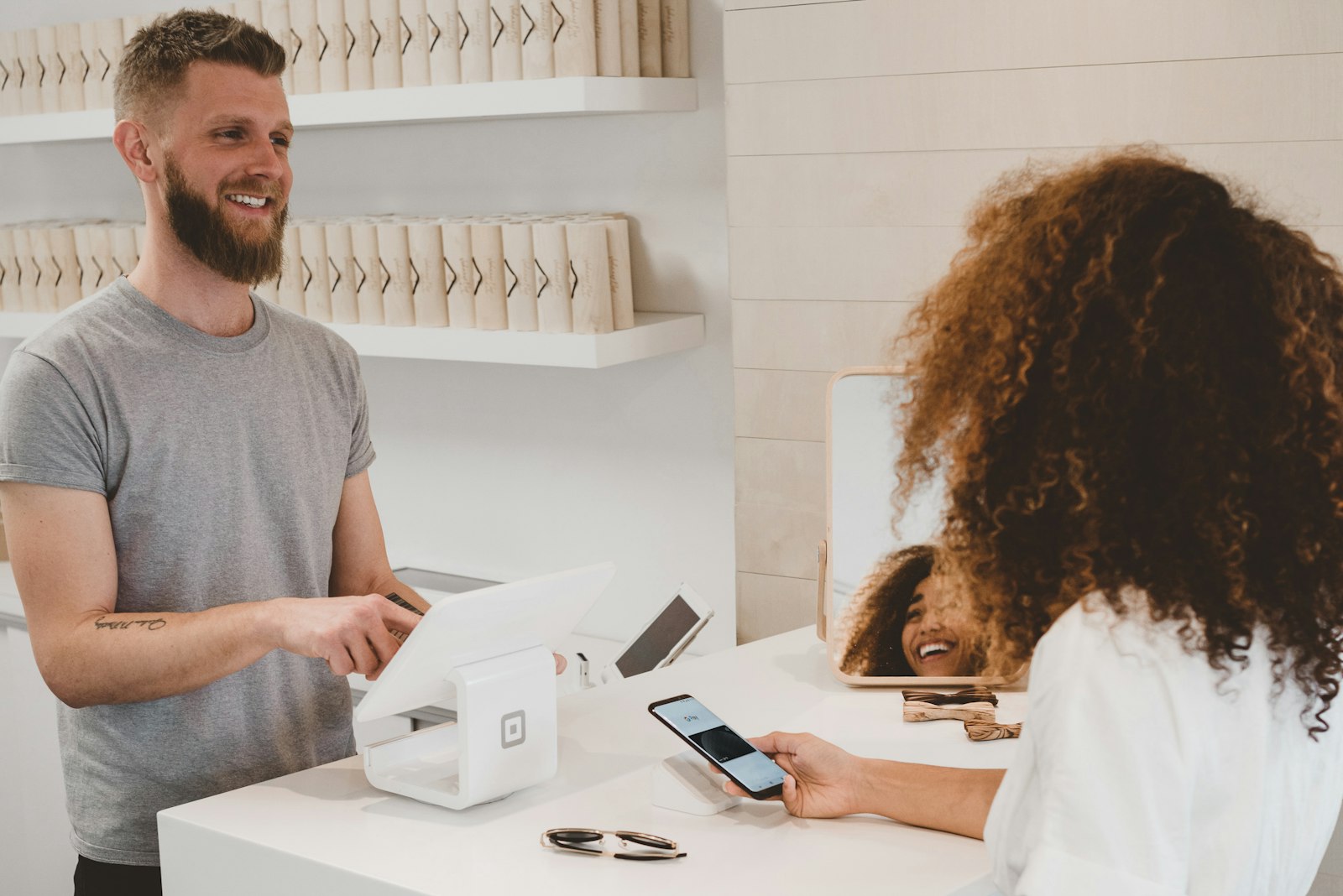 Customer paying via mobile at a retail counter